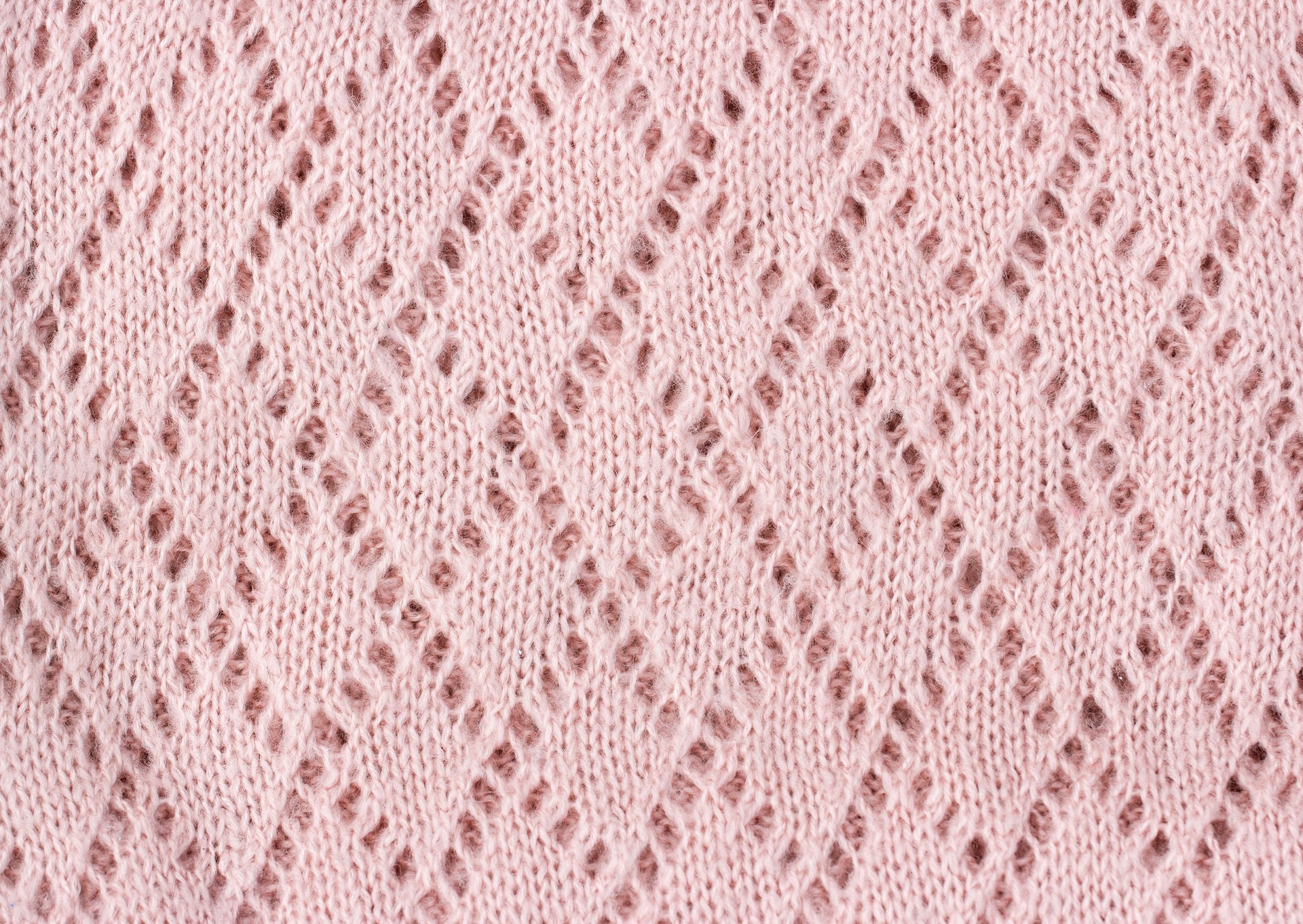 Pink knitted texture winter background.